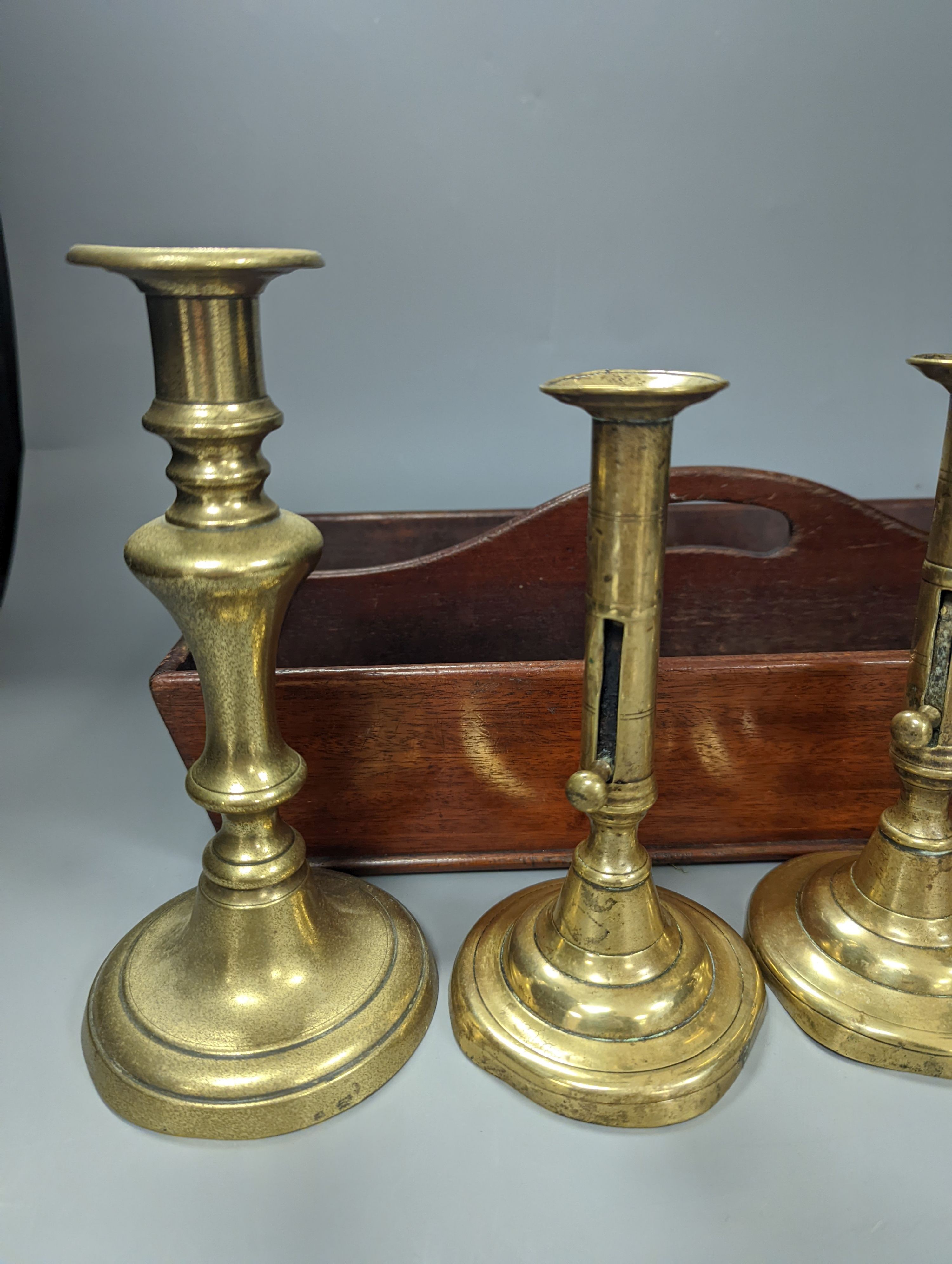 A pair of brass push-ejector candlesticks, a pair of Victorian brass candlesticks and a Victorian mahogany knife box, Knife box 38 cms wide.